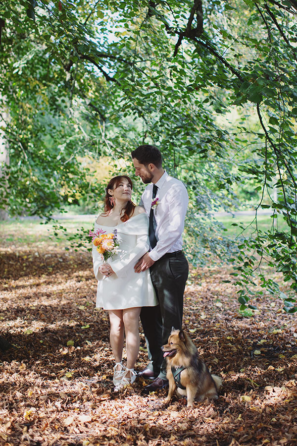 Relaxed Manchester wedding photography portrait of the couple with their dog Pedro after the ceremony