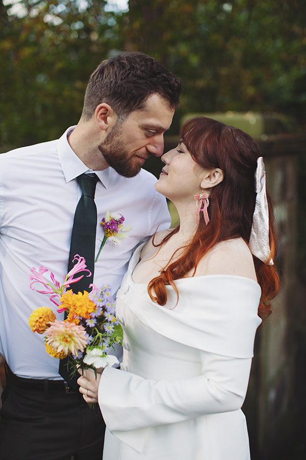 Relaxed Manchester wedding photography portrait of the couple with their dog Pedro after the ceremony
