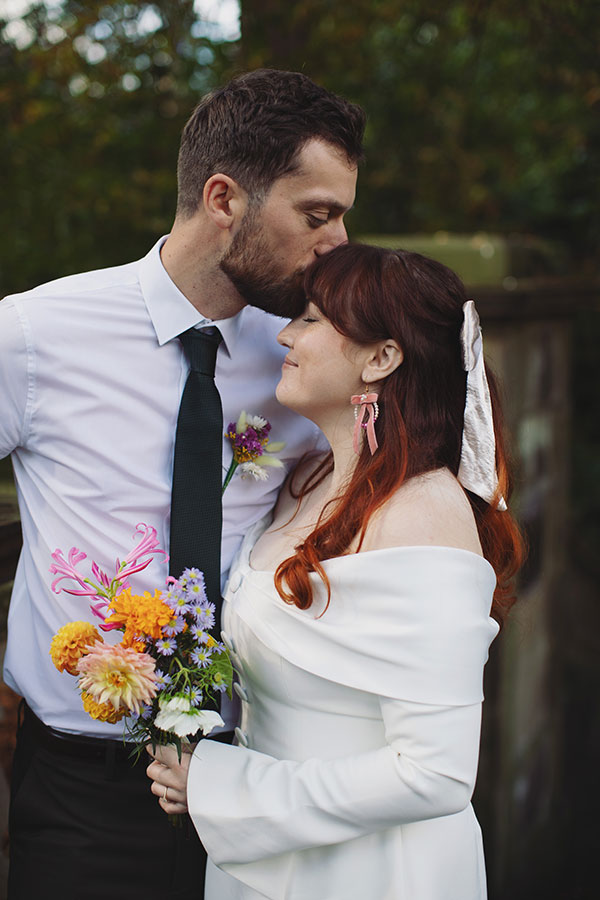 Manchester wedding photography capturing Rebecca and Tom with friends in the gardens