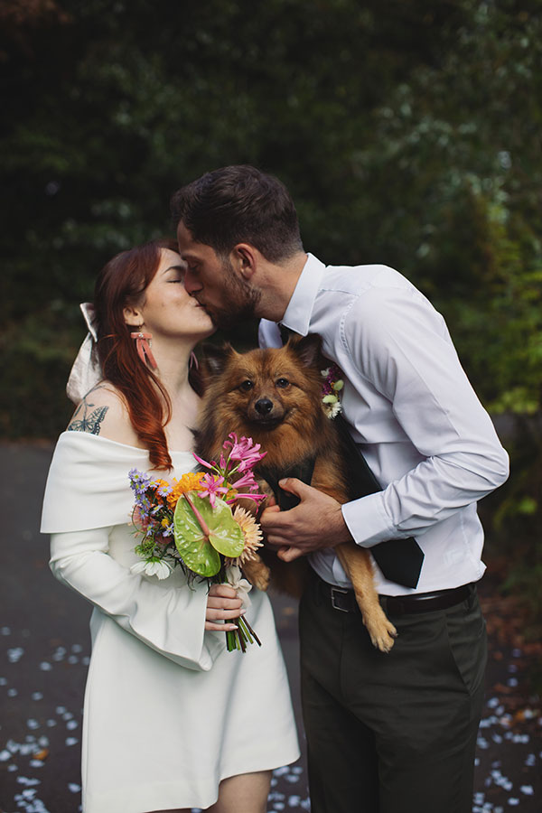 Confetti moment with a pet dog and Rebecca and Tom just married in Manchester