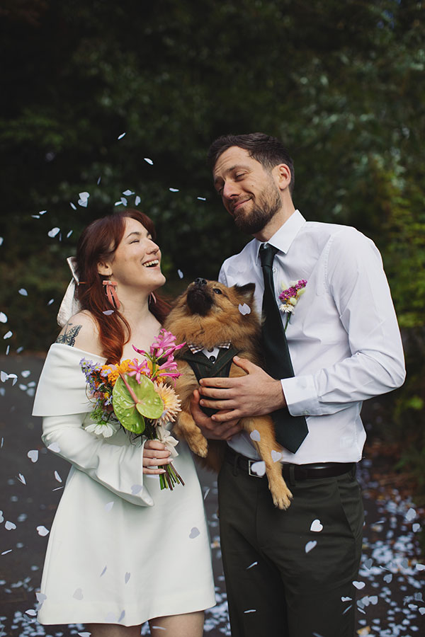 Confetti moment with a pet dog and Rebecca and Tom just married in Manchester