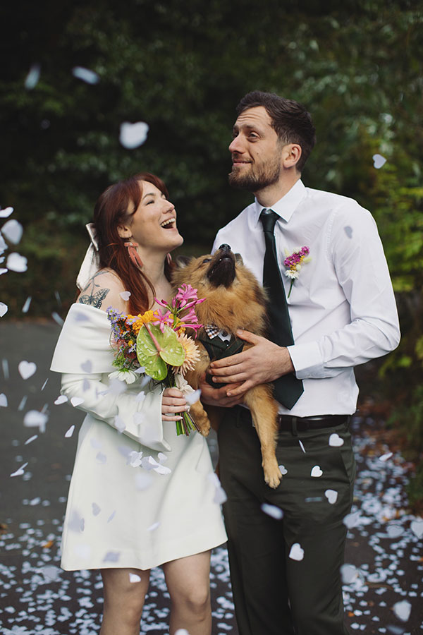 Confetti moment with a pet dog and Rebecca and Tom just married in Manchester