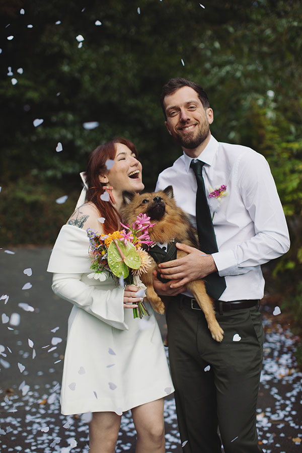 Confetti moment with a pet dog and Rebecca and Tom just married in Manchester
