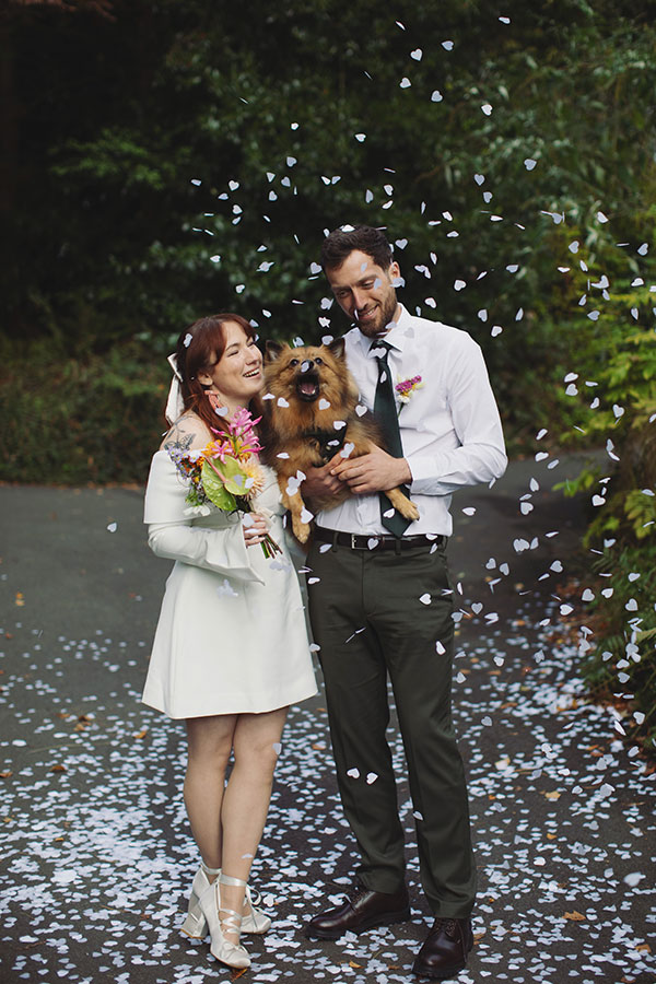 Confetti moment with a pet dog and Rebecca and Tom just married in Manchester