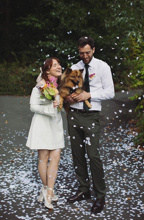 Confetti moment with a pet dog and Rebecca and Tom just married in Manchester
