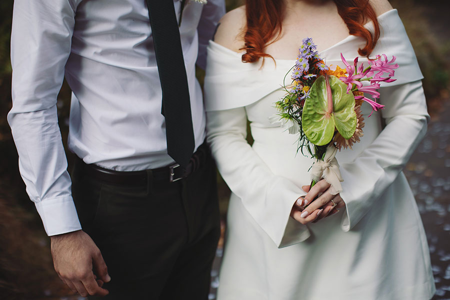 Bride with unusual plant wedding bouquet