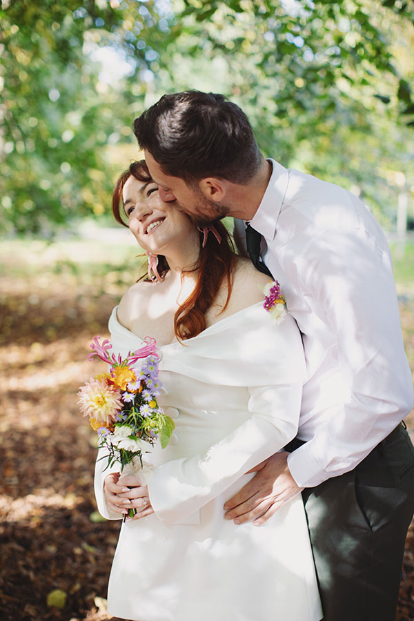 Relaxed Manchester wedding photography portrait of the couple with their dog Pedro after the ceremony