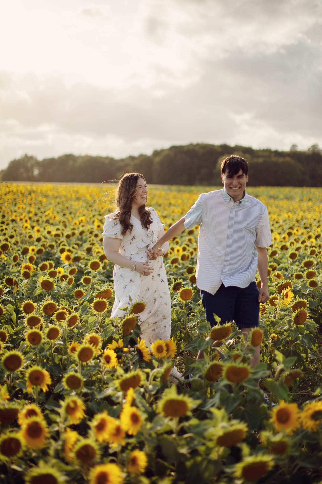 Natural portrait in sunflower field with soft evening light