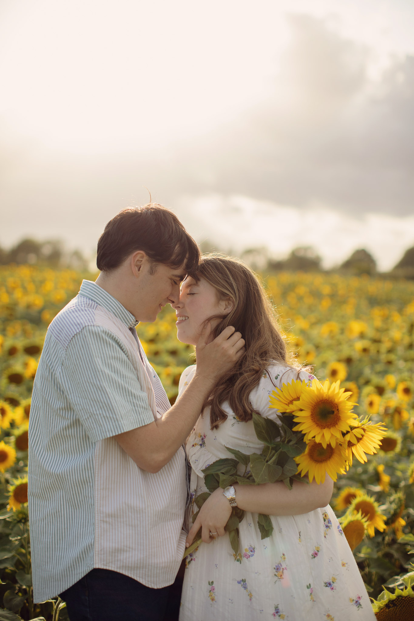 Natural portrait in sunflower field with soft evening light