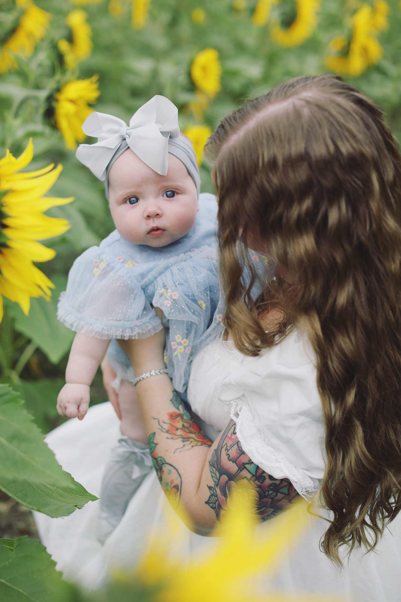 Portrait photography at Barlow Sunflower Fields with rows of bright yellow flowers