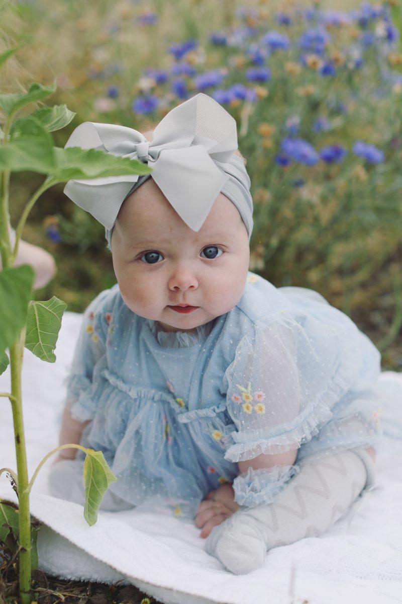 Summer portrait session surrounded by sunflowers in full bloom