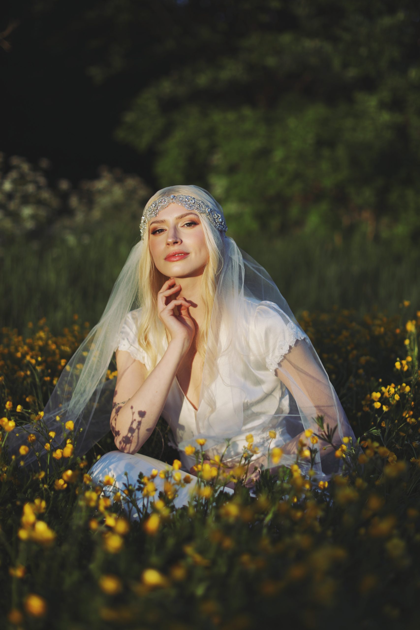 Romantic bride in a vintage-inspired wedding dress surrounded by tulips and warm sunset light