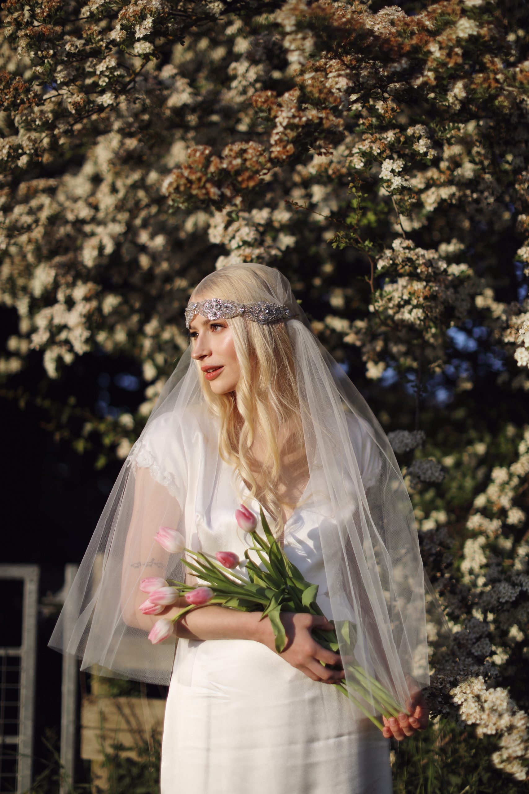 Whimsical bridal editorial featuring a modern romantic bride in a blooming garden