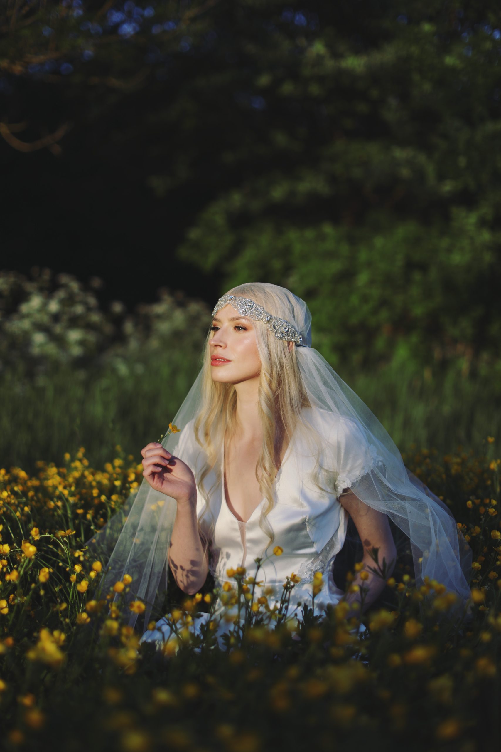 Romantic bride in a vintage-inspired wedding dress surrounded by tulips and warm sunset light