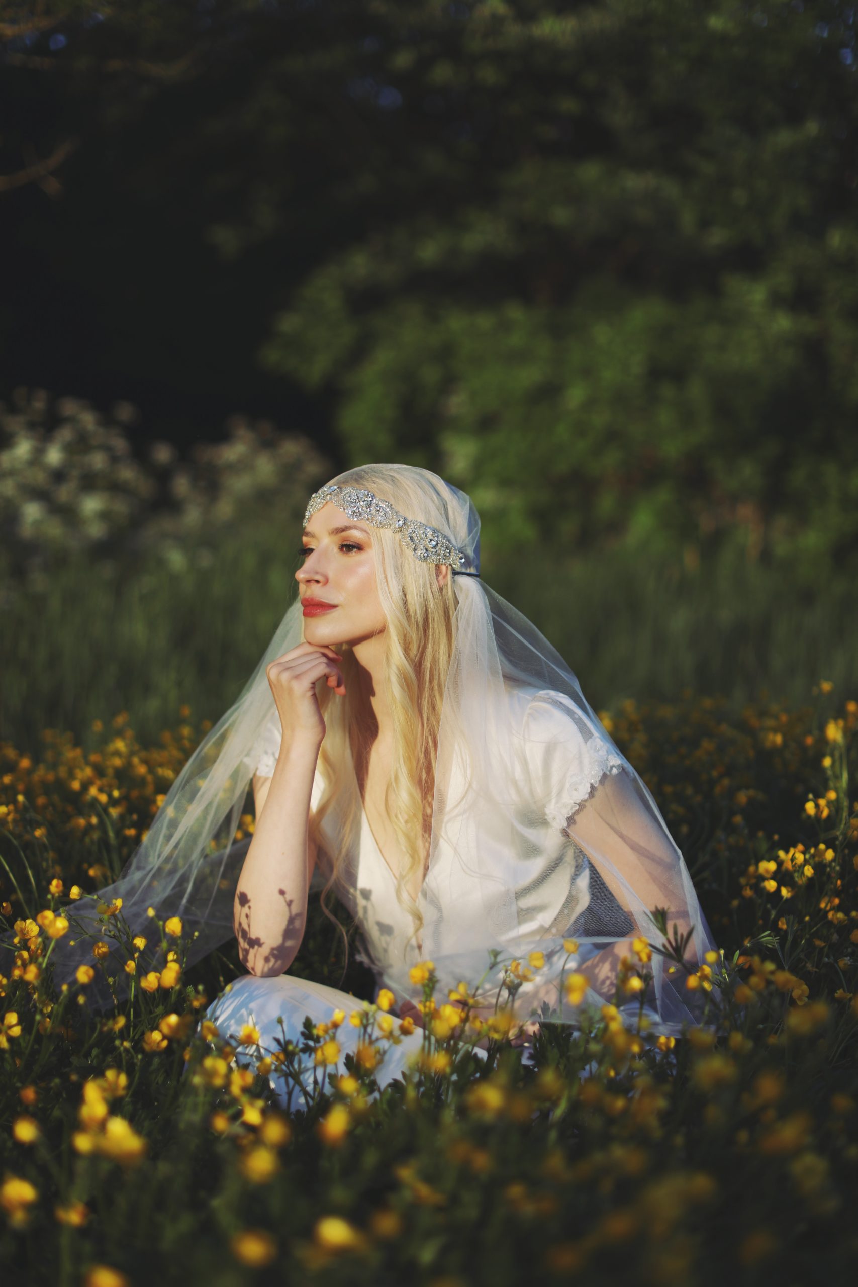 Romantic bride in a vintage-inspired wedding dress surrounded by tulips and warm sunset light