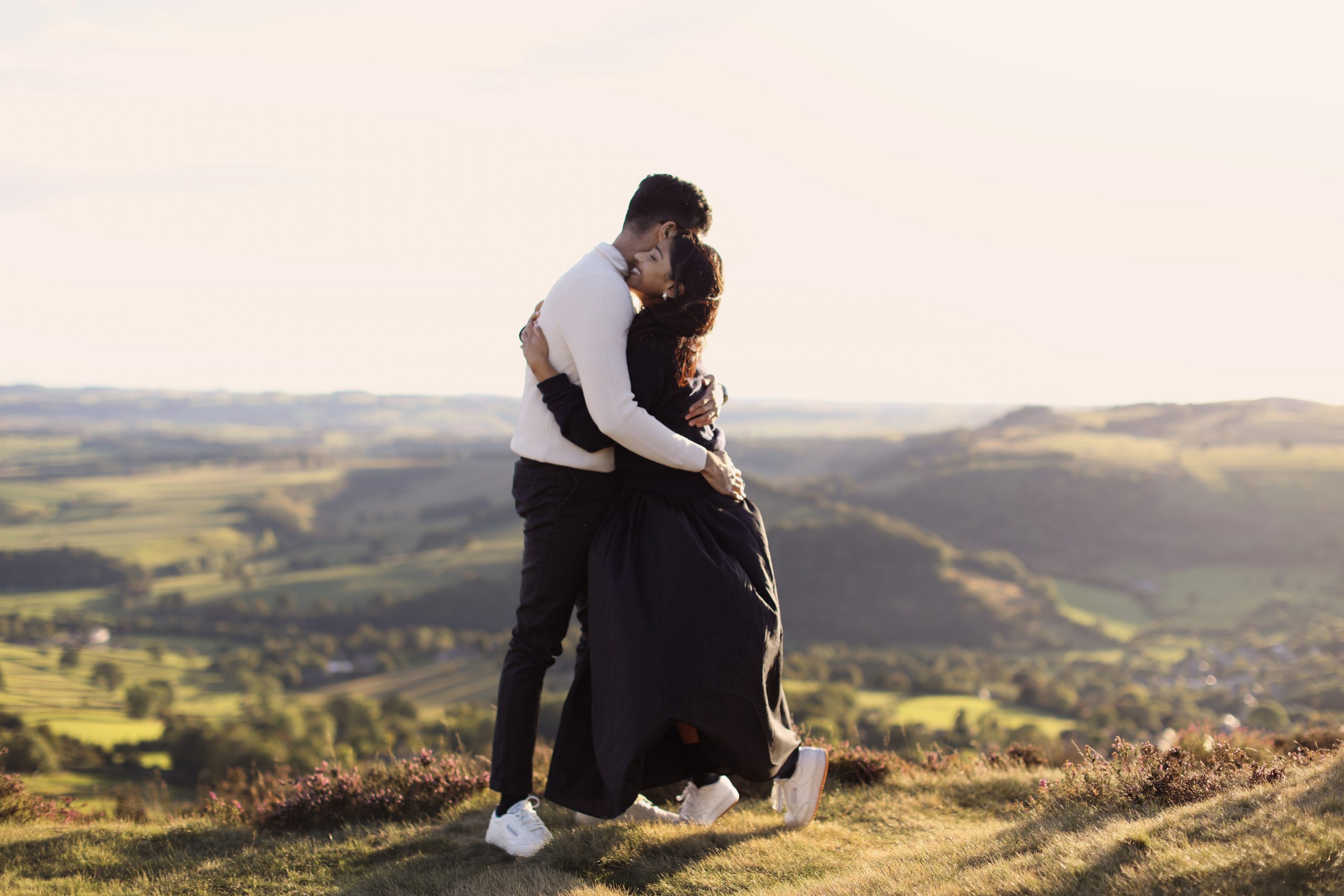 Peak District Proposal Photographer ♡ Rahul & Rhea’s Surprise Proposal at Curbar Edge 11 Couple standing together on Curbar Edge with views across the Peak District.