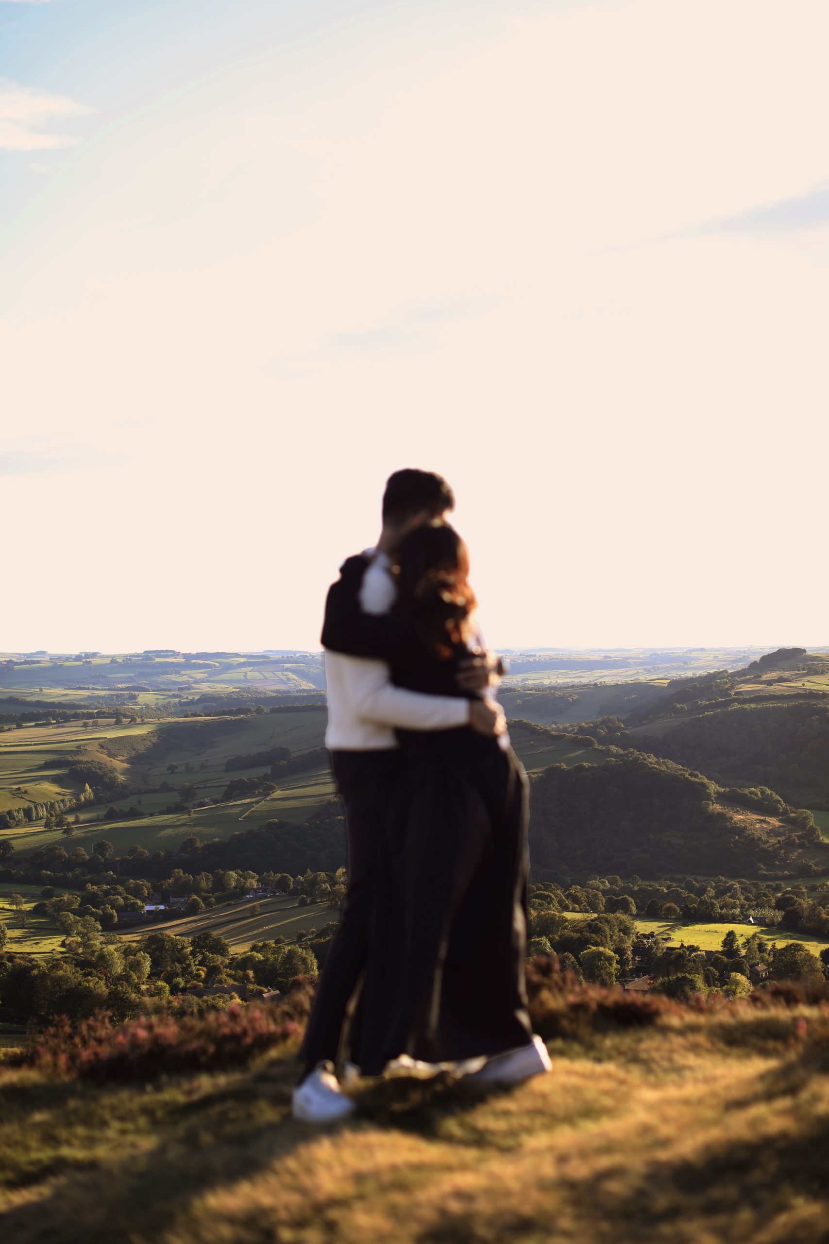 Peak District Proposal Photographer ♡ Rahul & Rhea’s Surprise Proposal at Curbar Edge 3 Couple standing together on Curbar Edge with views across the Peak District.