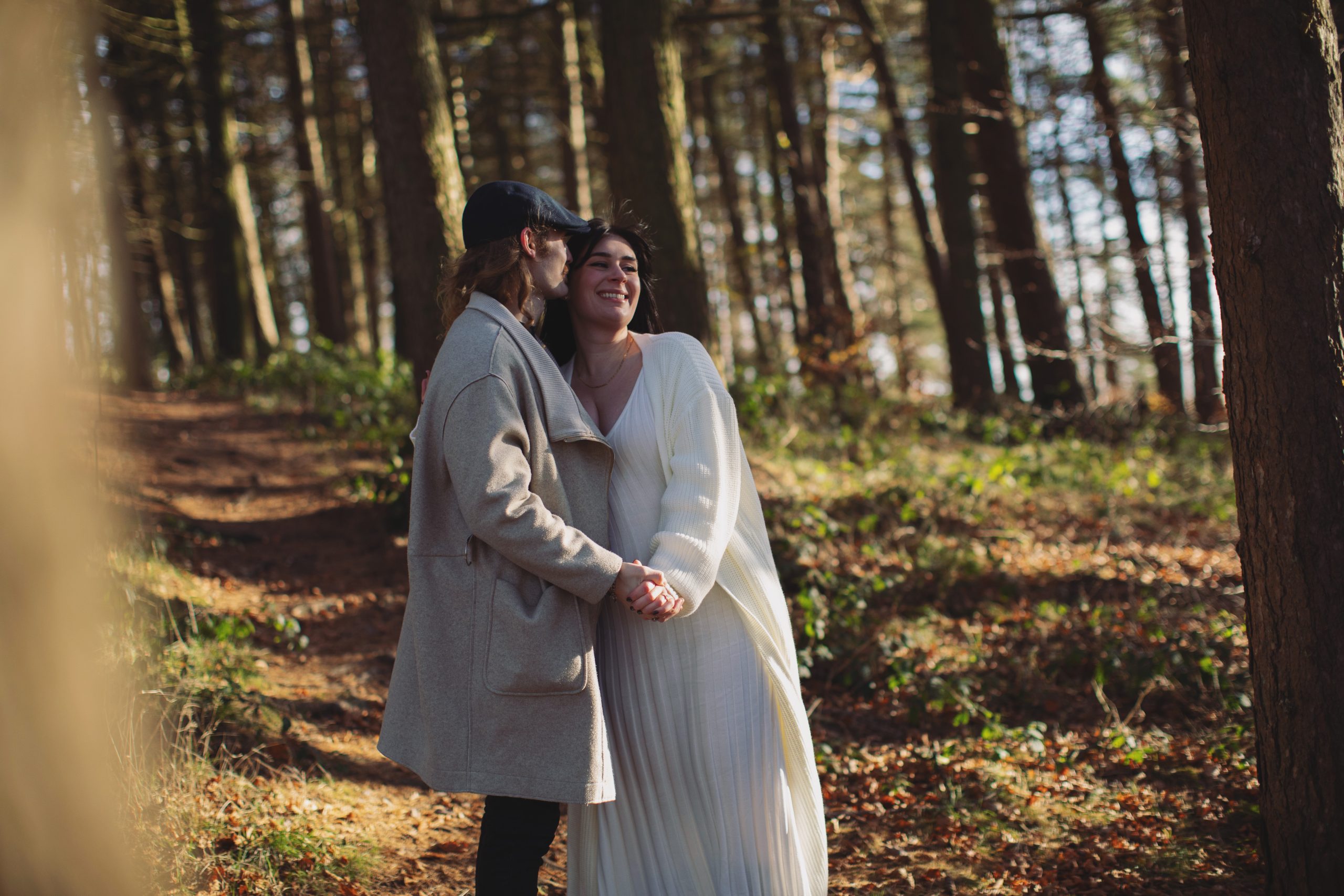 Cat & Liam ♡ Engagement Photoshoot at Shillito Woods 11 Engaged couple Cat and Liam standing among golden autumn leaves in Shillito Woods near Sheffield.