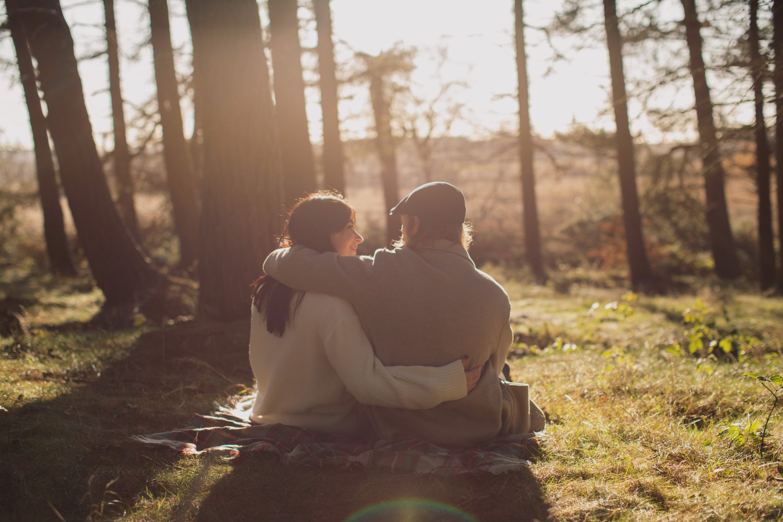 Cat & Liam ♡ Engagement Photoshoot at Shillito Woods 17 Cat and Liam embracing beneath tall trees during their outdoor engagement session at Shillito Woods.