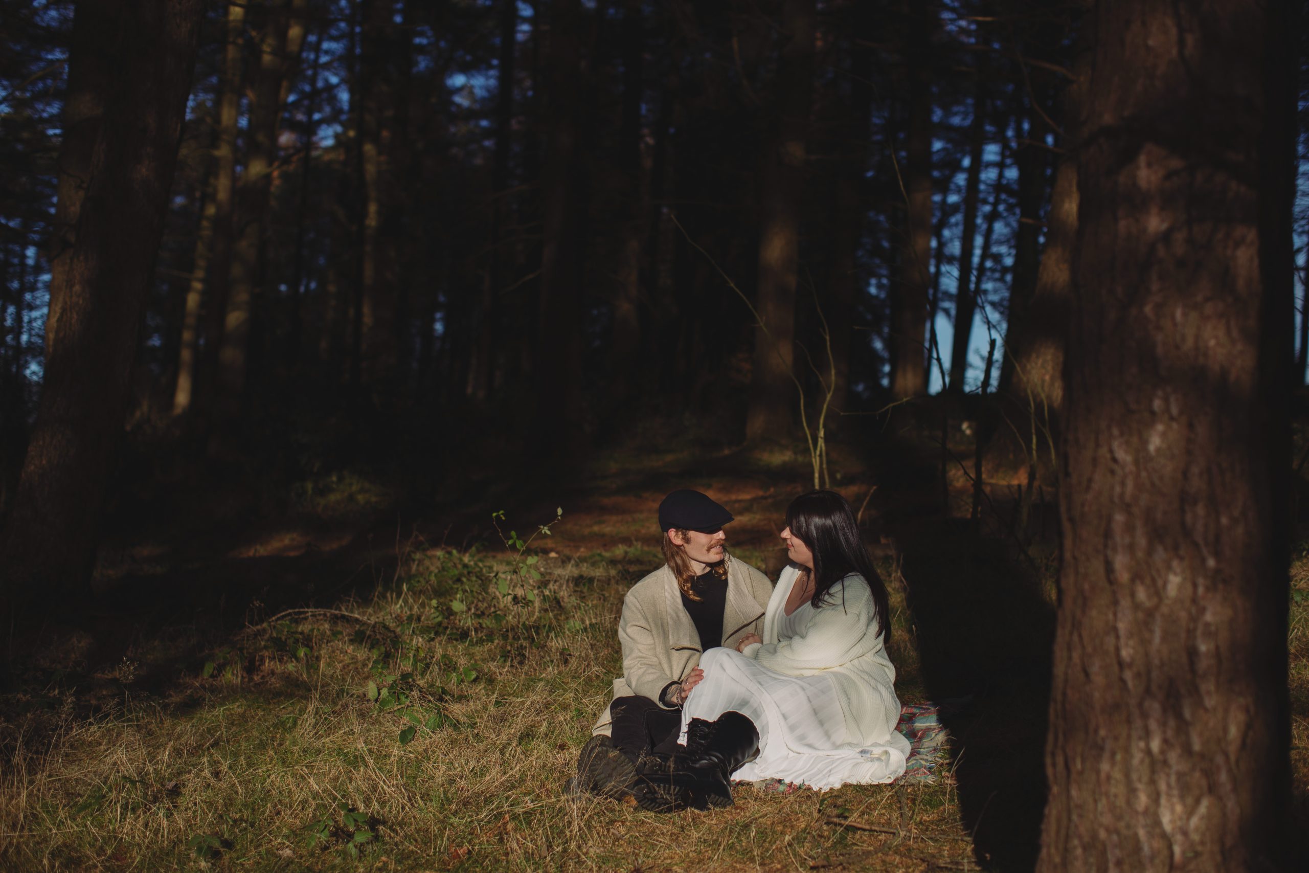 Cat & Liam ♡ Engagement Photoshoot at Shillito Woods 7 Cat and Liam embracing beneath tall trees during their outdoor engagement session at Shillito Woods.