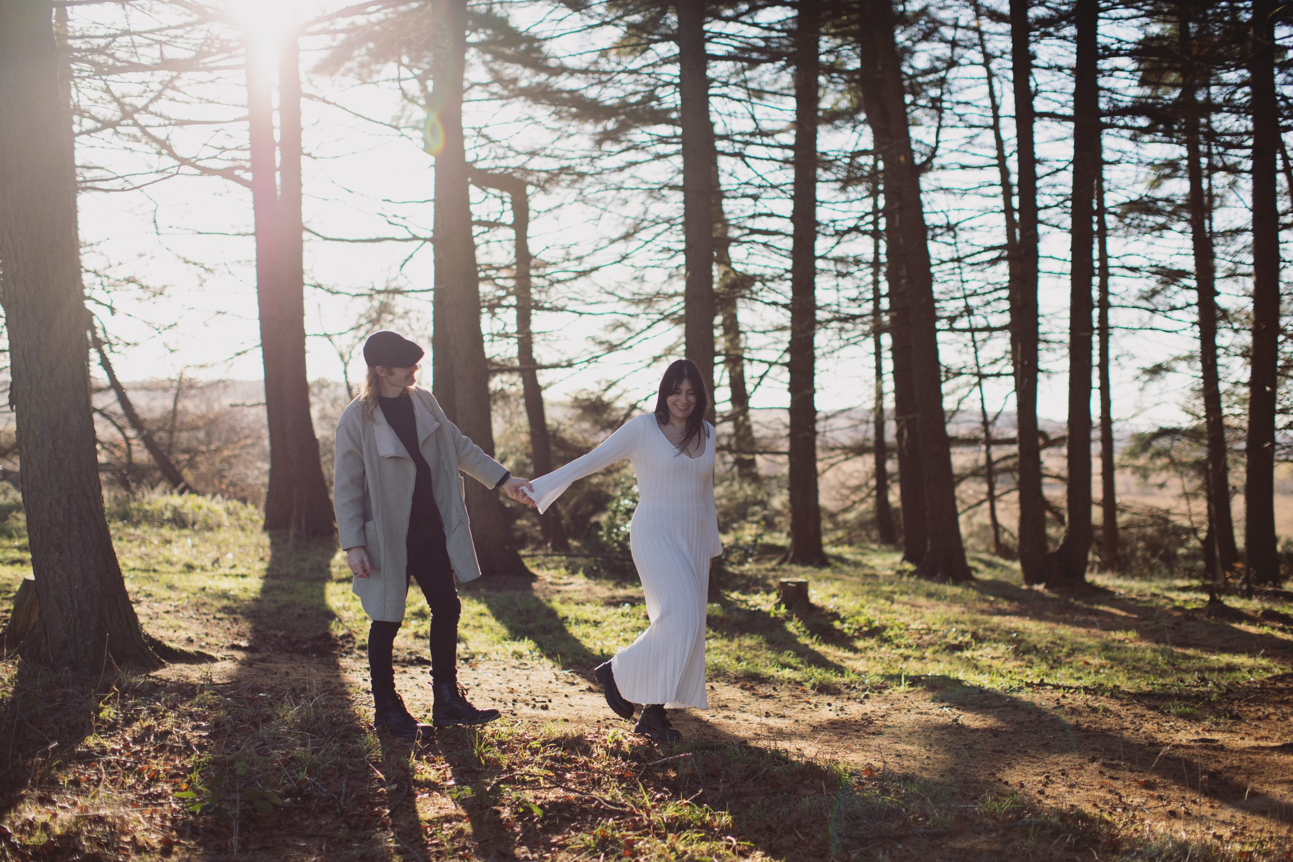 Cat & Liam ♡ Engagement Photoshoot at Shillito Woods 9 Cat and Liam embracing beneath tall trees during their outdoor engagement session at Shillito Woods.