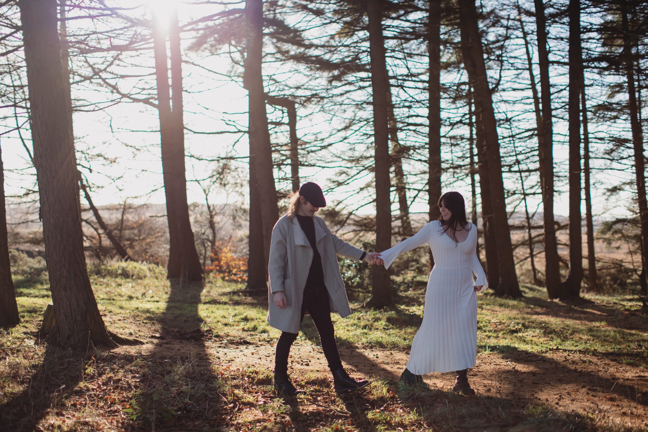 Cat & Liam ♡ Engagement Photoshoot at Shillito Woods 19 Cat and Liam embracing beneath tall trees during their outdoor engagement session at Shillito Woods.