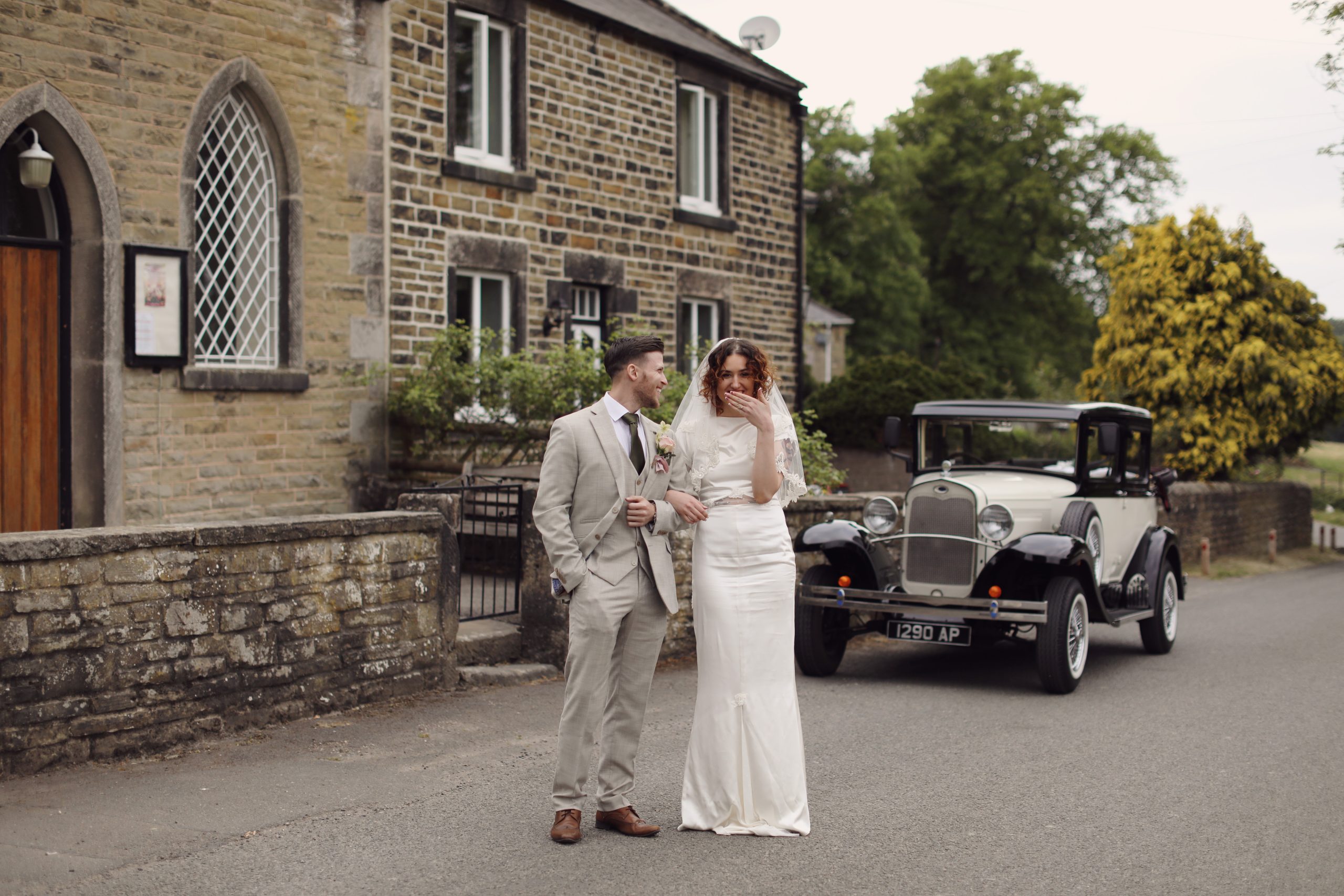 Bride and groom smiling together during a 1920s-inspired wedding styled shoot in the English countryside.
