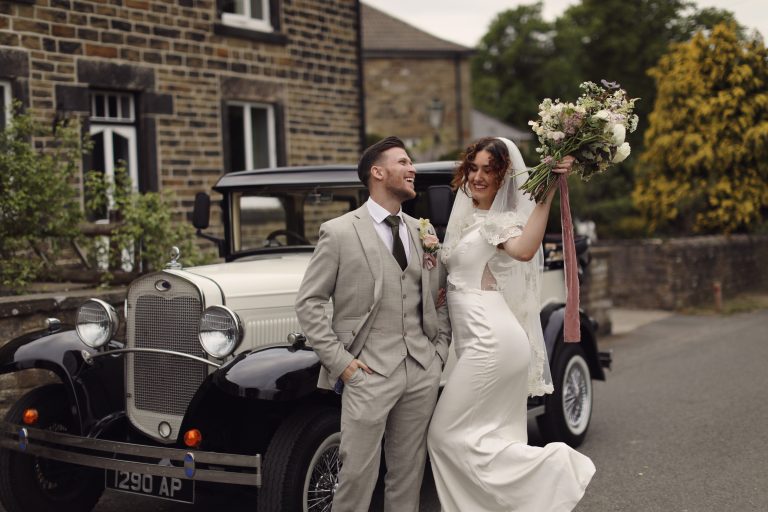 1920s-Inspired Wedding Styled Shoot 1 Bride laughing with groom outside a traditional Yorkshire stone house.