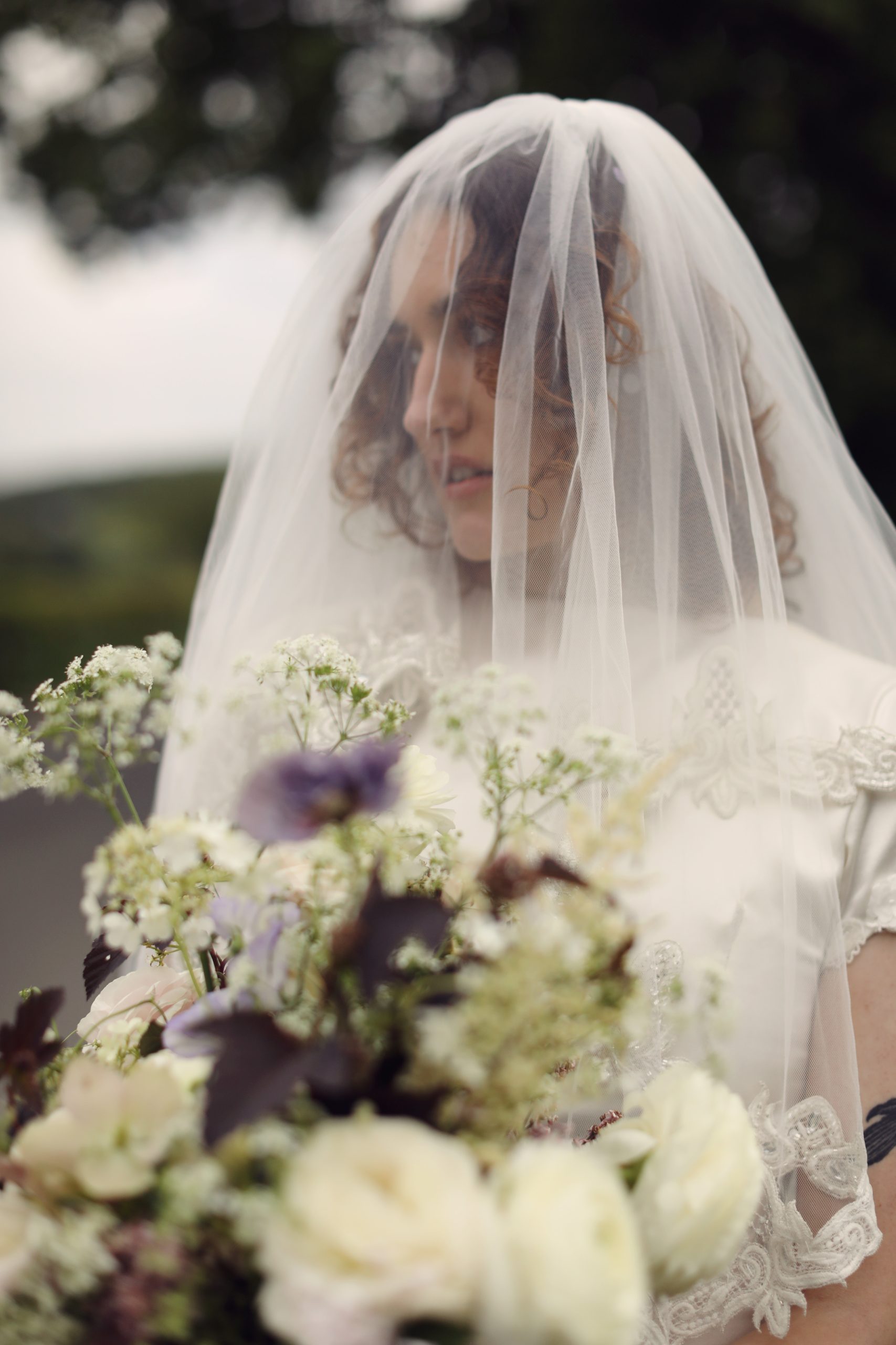 Elegant bridal portrait in a minimalist satin wedding dress.