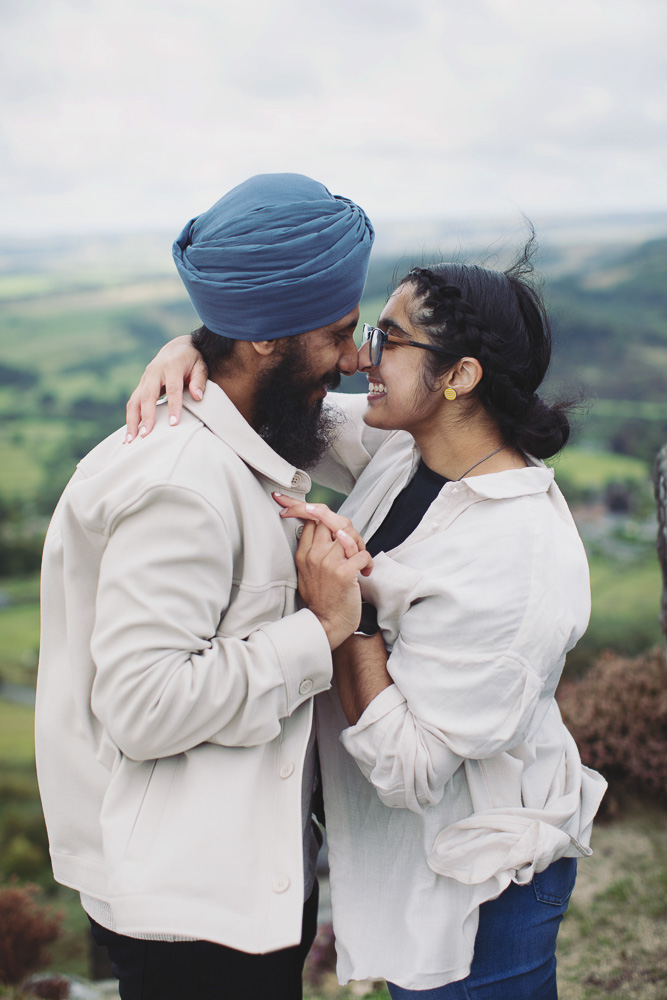 Wide view of a surprise proposal on a rocky Peak District viewpoint