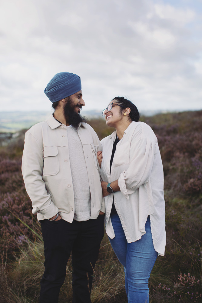 Newly engaged couple embracing after a surprise proposal in the Peak District