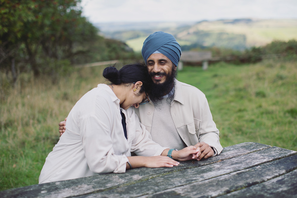 Newly engaged couple embracing after a surprise proposal in the Peak District
