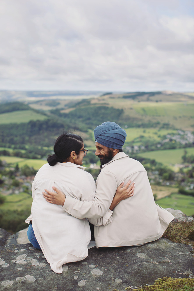 Wide view of a surprise proposal on a rocky Peak District viewpoint