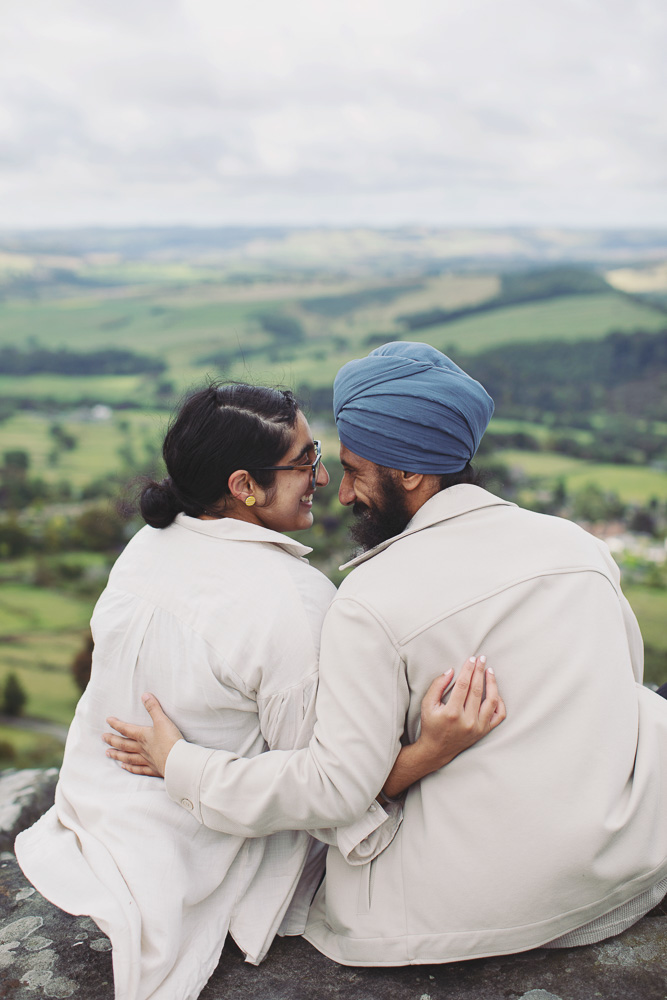 Wide view of a surprise proposal on a rocky Peak District viewpoint