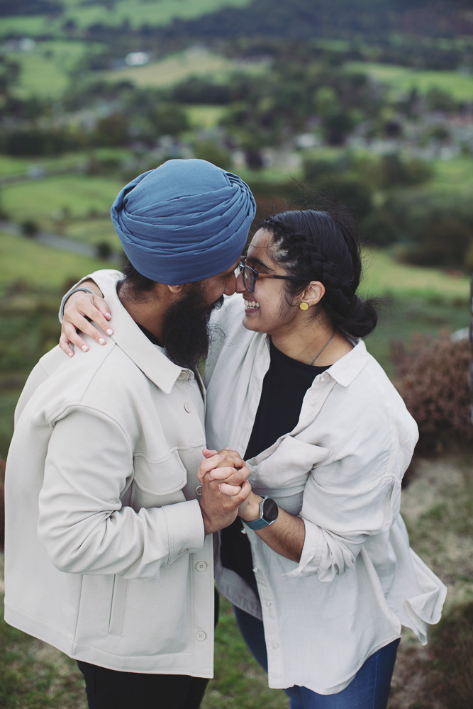 Wide view of a surprise proposal on a rocky Peak District viewpoint